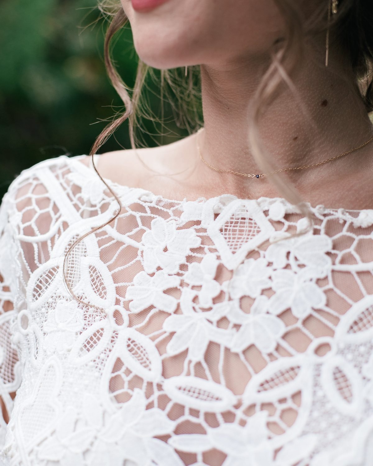 Close-up of fine ivory Chantilly lace over bare shoulder